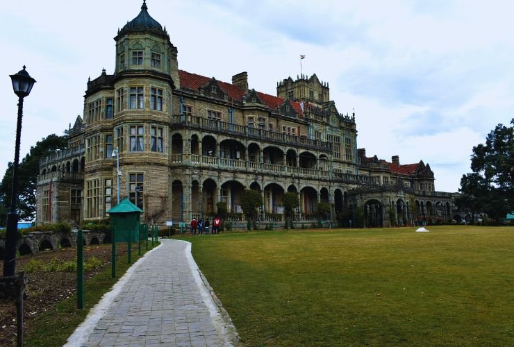 Exterior view of Viceregal Lodge Rashtrapati Niwas, iconic colonial mansion and top Shimla tourist place with towers, lawns, and pathway in Himachal Pradesh.

